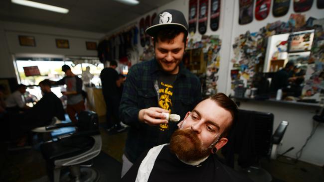 Barber Geordie Stavrou with customer Ben Ryland at Bare Bones Barber, Morningside. Picture: Stuart Quinn.