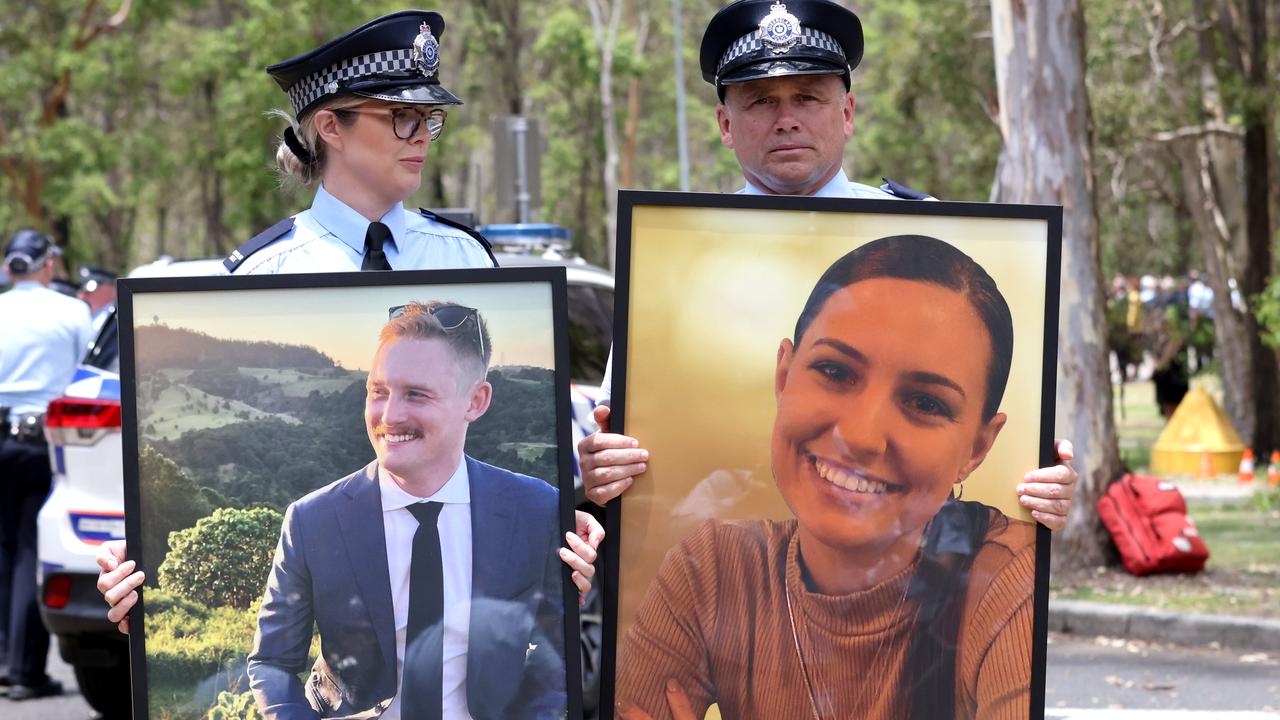 Officers carry the photos of Constable Rachel McCrow and Constable Matthew Arnold after their memorial at Brisbane Entertainment Centre, Boondall, on Wednesday 21st December 2022 – Photo Steve Pohlner