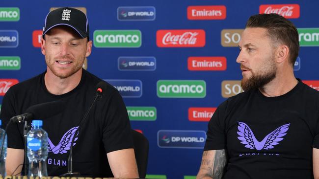 England's captain Jos Buttler (L) and England's coach Brendon McCullum (R) talk to the media at a press conference. (Photo by Sameer Ali/Getty Images)