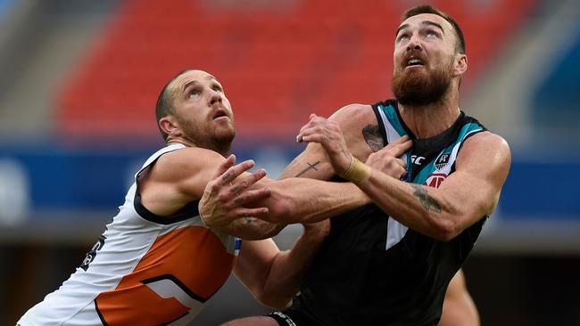 Port’s Charlie Dixon holds off Giants ruckman Shane Mumford as the Power held on for a win on the Gold Coast on Sunday that puts them firmly on top of the ladder&gt; Picture: Getty Images