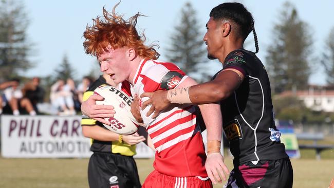 Langer Trophy game between PBC (red and white) and Marsden at Tugun. PBC's Baylen Donald wrapped up by Marsdens Markatato Nosa. . Picture Glenn Hampson