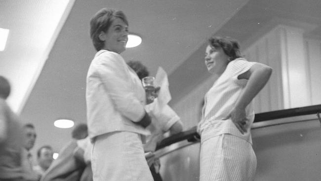 news/fashion 31/3/1965 Chained to the footrail in the public bar of the Regatta Hotel, Toowong, are Mrs Rosalie Bogner, left, of Indooroopilly, and Merle Thornton of Fig Tree Pocket. The pair relaxed with a glass of beer bought for them by a hotel patron. They were drawing attention to their campaign to give women the right to drink side-by-side with men in public bars. Picture by Bruce Postle RA212-2 pub 1/4/65 The Courier-Mail Photo Archive.