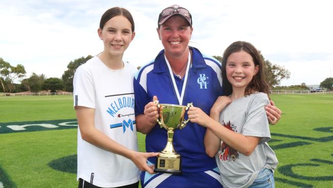 Kat Paton-Hodges holds Barwon Heads' A-grade premiership cup with daughters Zoe and Maddi. Picture: Meg Saultry