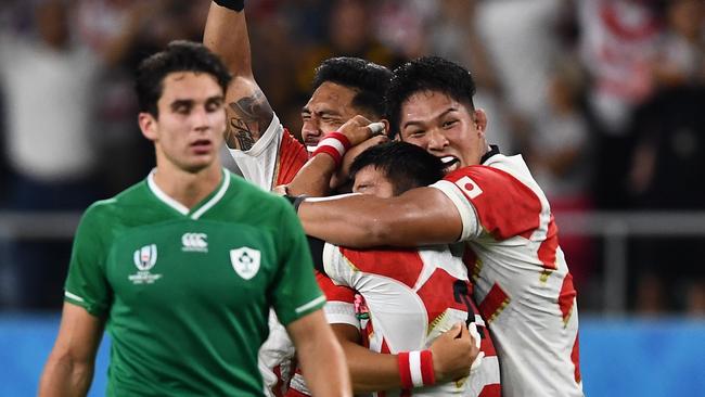 Japan's players celebrate after winning  the Japan 2019 Rugby World Cup Pool A match between Japan and Ireland at the Shizuoka Stadium Ecopa in Shizuoka on September 28, 2019. (Photo by Anne-Christine POUJOULAT / AFP)