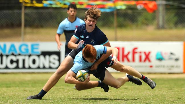 Jonathan Ryan of NSW is tackled during the match against the Barbarians.