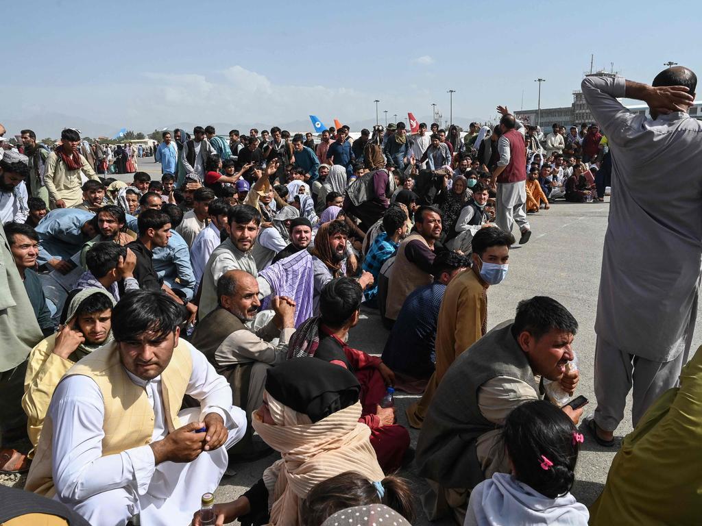 Afghan passengers sit as they wait to leave. Picture: Wakil Kohsar/AFP