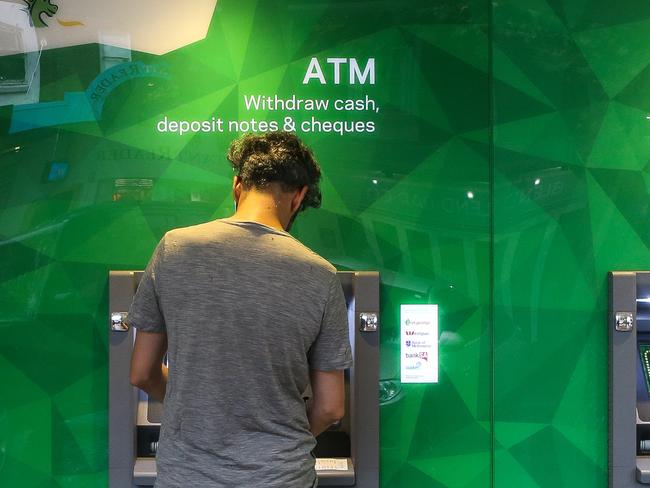 SYDNEY, AUSTRALIA - NewsWire Photos -FEBRUARY 22 2022: Pedestrians are seen walking past an ATM machine in Sydney. Picture: NCA Newswire / Gaye Gerard