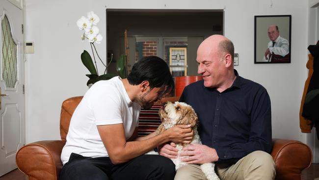 Trent Zimmerman with his partner Carlos Toledo and their dog at home on the North Shore.