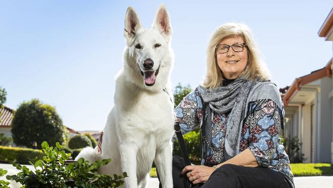 Kristeen Parsons travels the world looking after people's pets in luxury accomodation, pictured with Geisha the swiss white shepherd at North Lakes. Picture: Lachie Millard