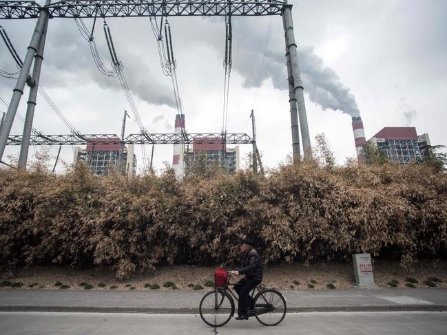 Aman passing the Shanghai Waigaoqiao Power Generator Company coal power plant in Shanghai. Picture: AFP