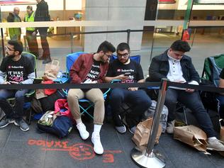 Customers wait in line for new products at the Apple Store in Sydney, Friday, September 22, 2017. Tech giant Apple have today released the iPhone 8 and iPhone 8 Plus smartphones. (AAP Image/Joel Carrett) NO ARCHIVING