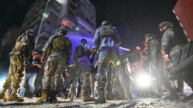 Lebanese soldiers secure a building hit by an Israeli air strike. Picture: AFP