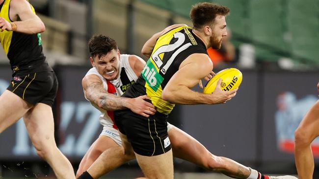 MELBOURNE, AUSTRALIA – JUNE 25: Noah Balta of the Tigers injures his leg as Josh Battle of the Saints tackles him during the 2021 AFL Round 15 match between the Richmond Tigers and the St Kilda Saints at the Melbourne Cricket Ground on June 25, 2021 in Melbourne, Australia. (Photo by Michael Willson/AFL Photos via Getty Images)