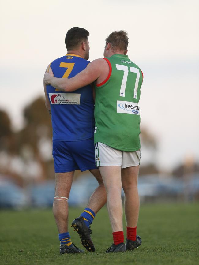 Marc Holt is consoled by Tooradin-Dalmore defender Mathew Sloper after finishing the day on 999 career goals. Picture: Valeriu Campan