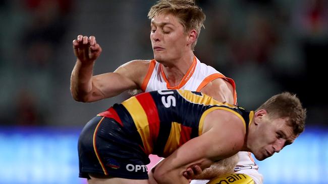 Jackson Hately puts a tackle on Adelaide midfielder Rory Laird this season.