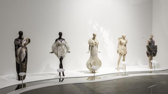 An installation view of Iris van Herpen: Sculpting the Senses including Genesis dress, from the Meta Morphisma collection 2022 by Iris van Herpen; Empyrean dress, Empyrean gown and Magnetosphere dress, from the Earthrisea collection 2021 by Iris van Herpen with collaborators Rogan Brown and Parley for the Oceans; Hypnagogia dress, from the Lucida collection 2016 by Iris van Herpen © Iris van Herpen. Picture: N Umek © QAGOMA