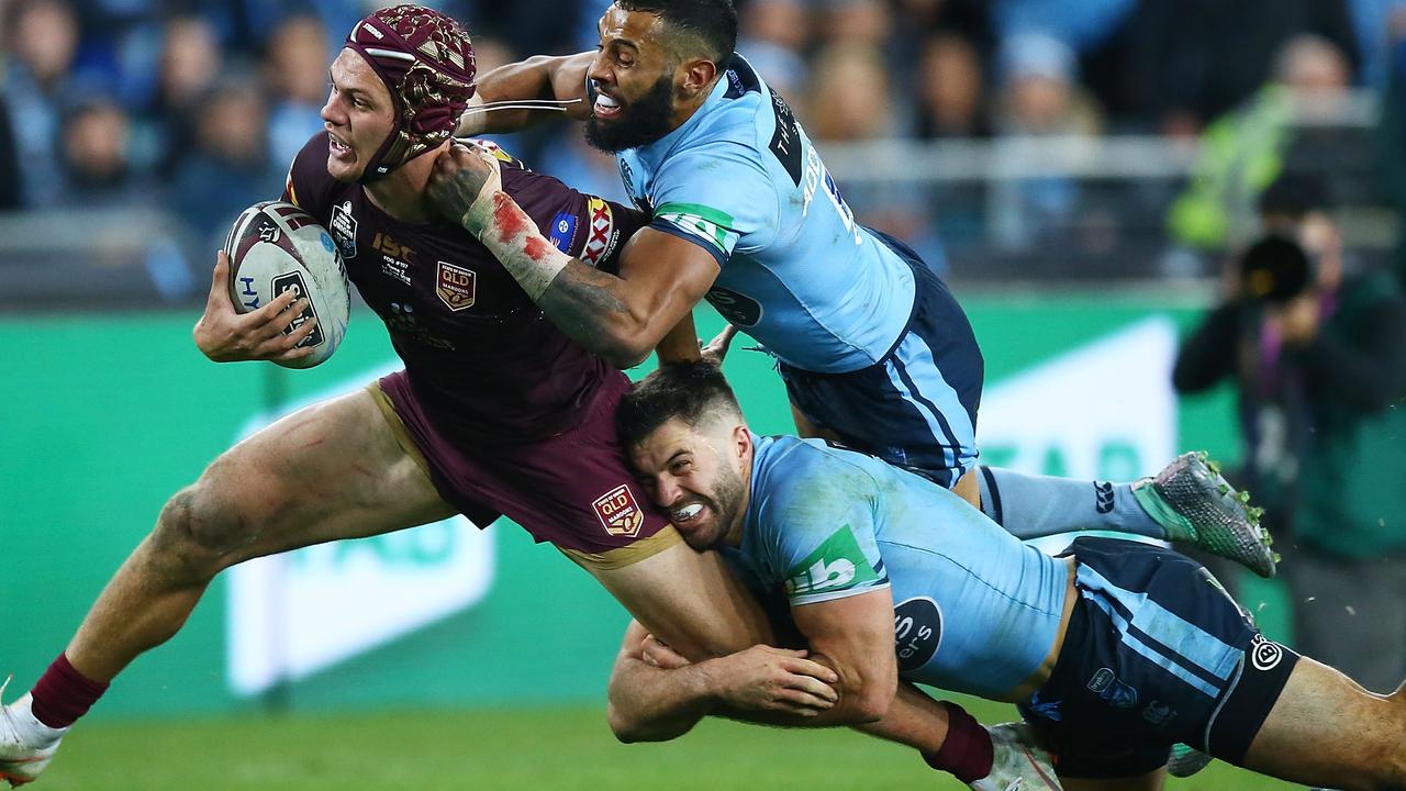 Kalyn Ponga of the Maroons is brought down by James Tedesco and Josh Addo-Carr.