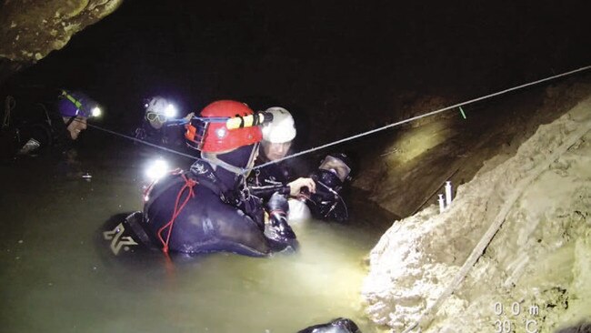 One of the Thai cave boys with his full mask on supported by members of the cave diving team including Chris Jewell, Rick Stanton and John Volanthen. Picture: Richard Harris