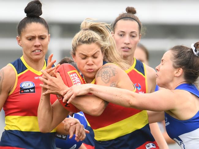 HOBART, AUSTRALIA - MARCH 07: Anne Hatchard of the crows is tackled during the round five AFLW match between the North Melbourne Kangaroos and the Adelaide Crows at North Hobart Oval on March 07, 2020 in Hobart, Australia. (Photo by Steve Bell/Getty Images)