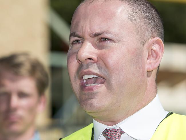 TERRIGAL, AUSTRALIA - NewsWire Photos OCTOBER 13, 2020. Federal Treasurer Josh Frydenberg speaks to the media as Ryan Wilson from Terrigal Electrical Services looks on, at a construction site at Terrigal on the NSW Central Coast. Picture: NCA NewsWire / Troy Snook