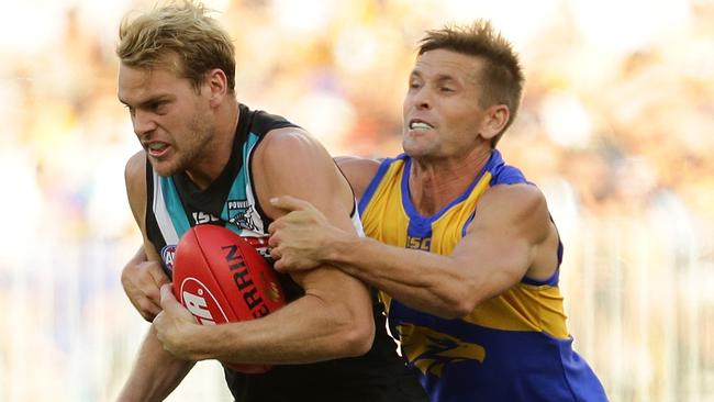 Jack Watts is tackled by Mark LeCras during the Power’s loss to the Eagles last week. Picture: Will Russell/AFL Media/Getty Images