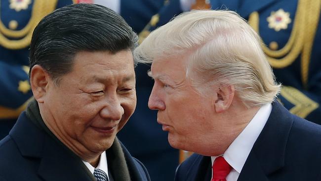 US President Donald Trump, right, chats with Chinese President Xi Jinping during a welcome ceremony at the Great Hall of the People in Beijing. Picture: AP Photo/Andy Wong