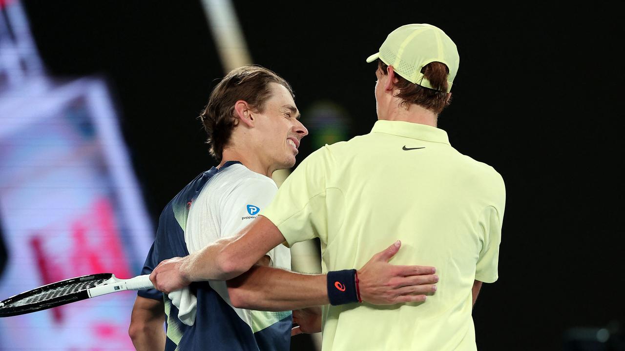 Jannik Sinner (right) embraces Alex de Minaur after the match. (Photo by Martin KEEP / AFP)