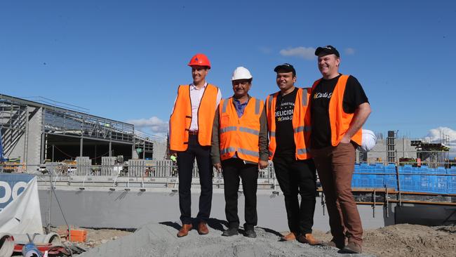 Fast-food outlet Carl Jr is opening at Hope Island Marketplace. From left are CBRE’s Rudi Scutti, and Bansal Group’s Premnath and Gaurav Bansal and Shawn Kerr. Picture Mike Batterham