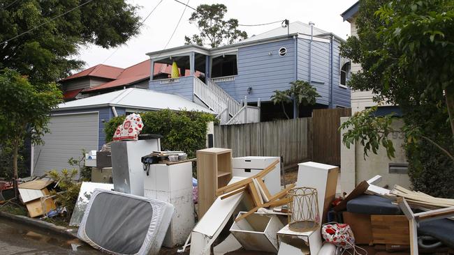. Debris is seen piled up outside a home in Milton. Picture: Tertius Pickard