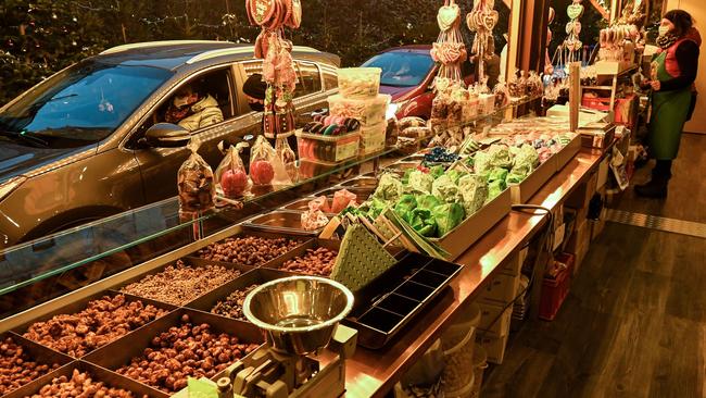 Christmas sweets are offered in a sales booth at the drive in Christmas market in Landshut, southern Germany. Picture: AFP