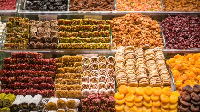 Well ordered shelves of delicious Turkish delights, candies and confections entice shoppers at the Istanbul Spice bazaar in Turkey.