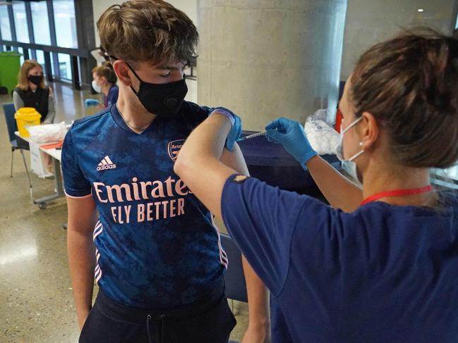 A teenager receives the vaccine Tottenham Hotspur's football stadium in London. Picture: AFP