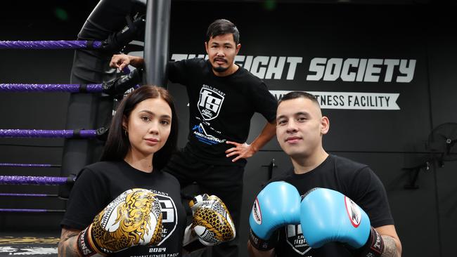 The Fight society opens this weekend at Nerang. Tegan Daly with partner and owner Brandon Baresic being watched over by coach Gob Teerawat.. Picture Glenn Hampson