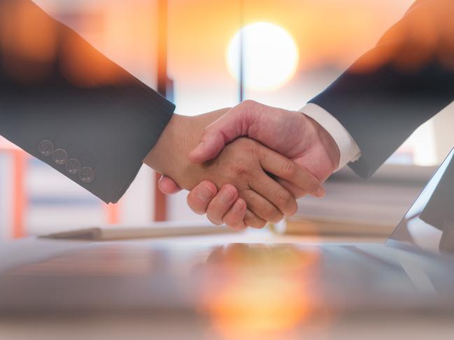 Businessmen handshaking with partner greeting dealing for business, finance and investment background, teamwork and successful business  joint venture concept with sunrise background; merger deal generic