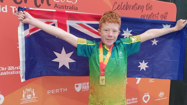 Robbie Yates with the Australian Flag at the World Transplant Games in Perth. Picture: Supplied