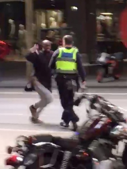 Bourke St terrorist Hassan Khalif Shire Ali lunges at a police officer.