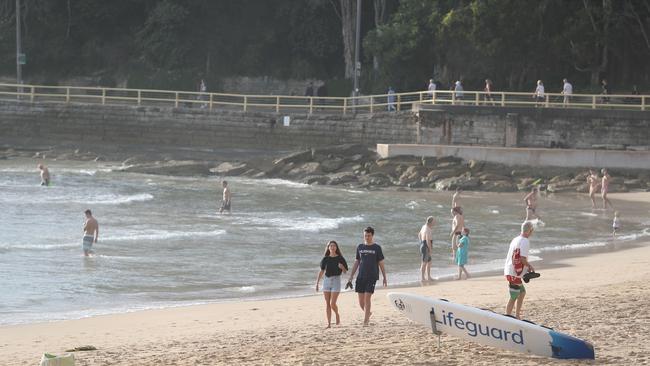 People exercising and swimming on the Corso and Manly Beach this morning. Picture: Rohan Kelly