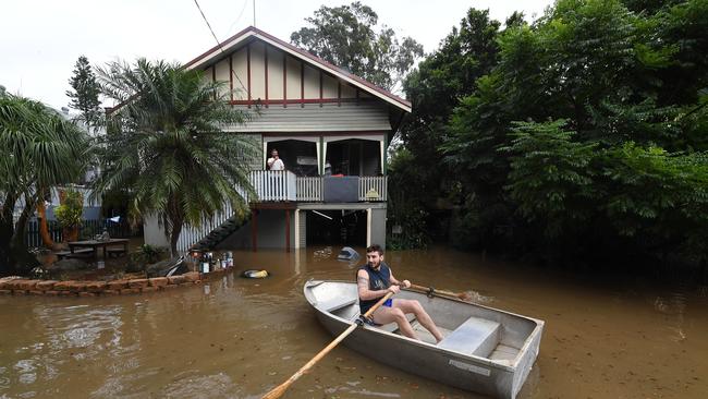 Lennon Bartlett rows a boat to his parents house next door to where he lives in central Lismore, New South Wales, Friday, March 31, 2017. The Wilsons River breached its banks early morning flooding the far-northern NSW town. (AAP Image/Dave Hunt) NO ARCHIVING