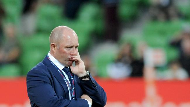 Rebels coach Tony McGahan watches his team during a warm-up session.