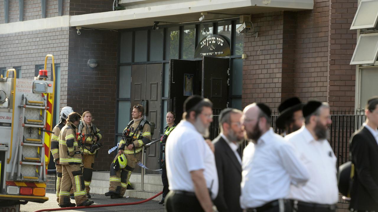 People continue to gather outside a synagogue at East St Kilda after an overnight fire. Picture: NewsWire/ Andrew Henshaw