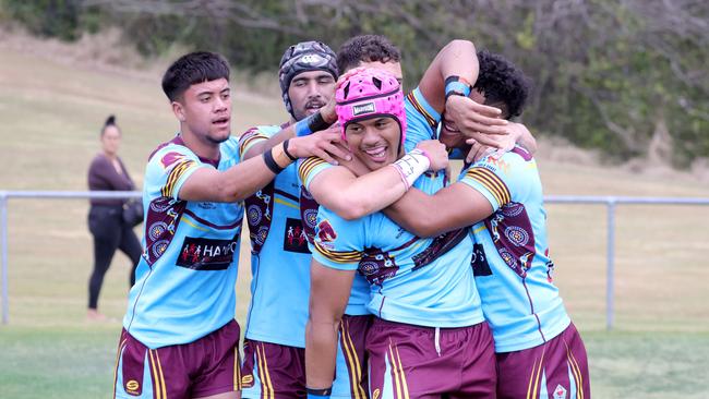 Jubilation after No.3 Joseph Tupuse scores a try (pink head gear). Photo: Steve Pohlner