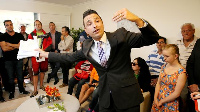 An auctioneer takes bids on a property from a large group of buyers. Negative gearing would have little effect on the final price. Picture: Troy Snook