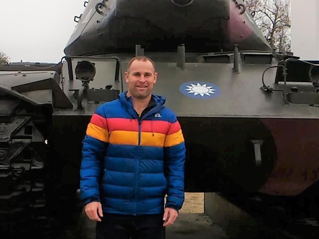 Aidan Ellis-Patterson, a Tasmanian who lives on the Taiwanese island of Kinmen, next to one of the many tanks dotted around the island.