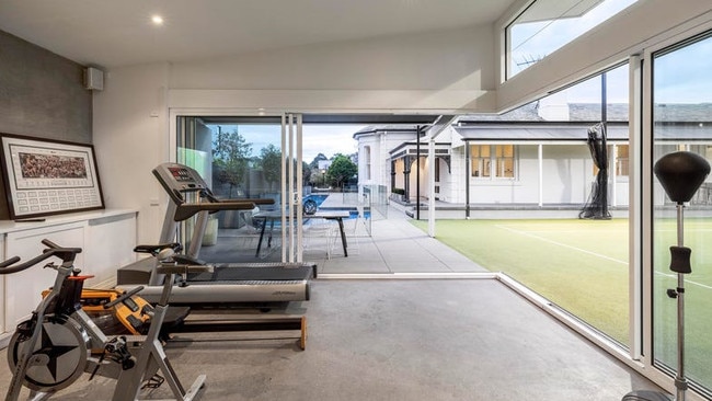 The house features a gym, tennis court and pool house.