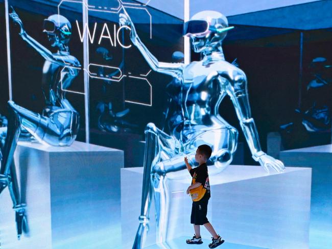 (FILES) A child visits the World Artificial Intelligence Conference (WAIC) in Shanghai on July 6, 2023. China's newest regulations on artificial intelligence-generated content came into effect on August 15, laying out legal guidelines for the fast-evolving field as the country juggles its authoritarian grip on online content with its push to get ahead in the AI race. (Photo by WANG Zhao / AFP)