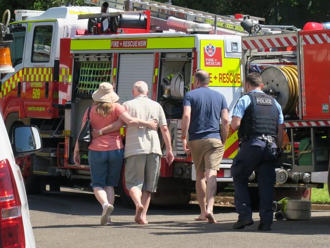 People comfort each other after a fire tore through a split level brick and fibro house at Shona Close, Narara, on January 3, 2023. Picture: NewsLocal