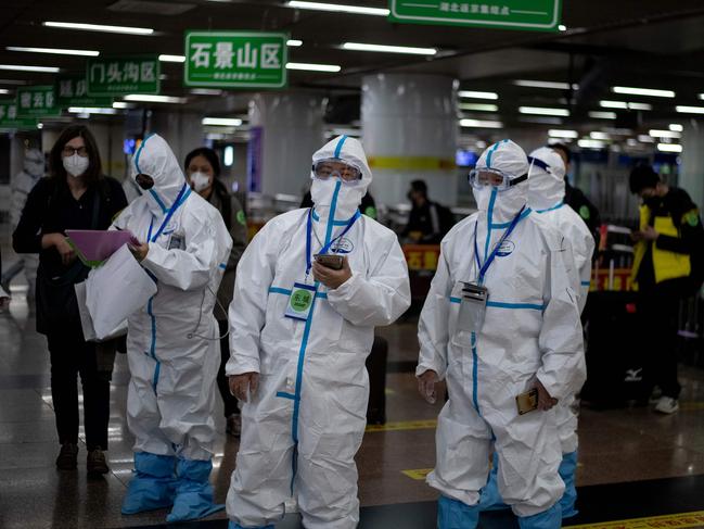 Transport personnel waiting for travellers arriving from Wuhan to take them to their quarantine locations. Picture: Noel Celis/AFP