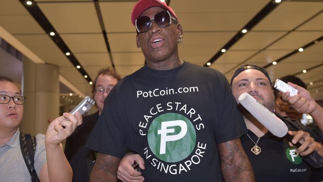 Retired American professional basketball player Dennis Rodman speaks to the press as he arrives at Changi International airport.