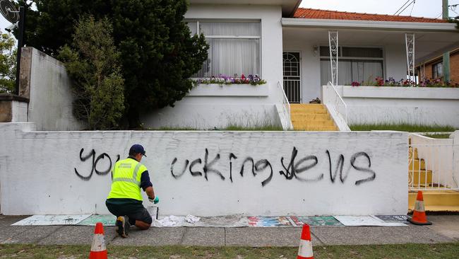 A council worker is seen working to remove the graffiti at a house next door to the Mount Sinai College in Maroubra. Picture: NewsWire/ Gaye Gerard