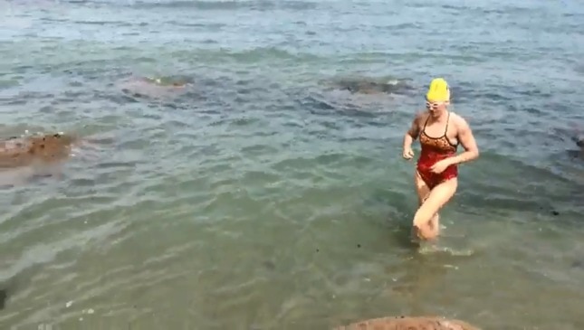 Emily Miers lands in France after marathon swim.